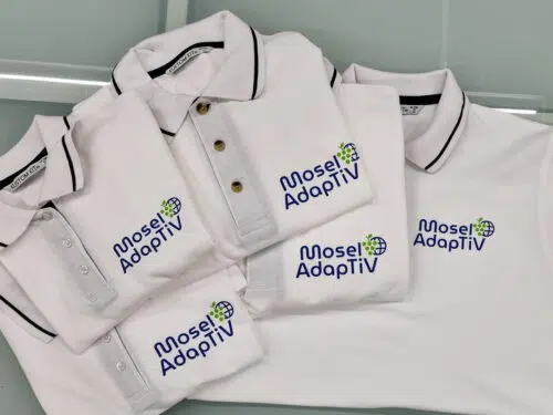 Hellgraue und weiße Poloshirts mit bedrucktem Logo Mosel AdaptiV
