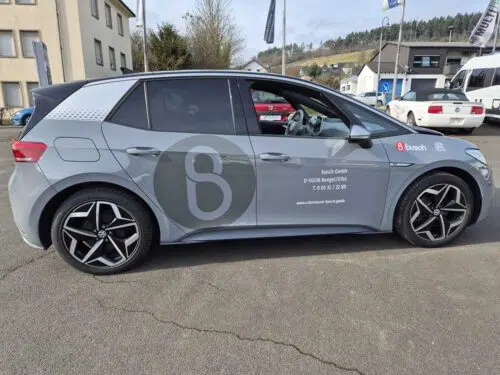 Weißer VW ID.3 mit grauem Firmenmonogramm und Beschriftung der busch GmbH